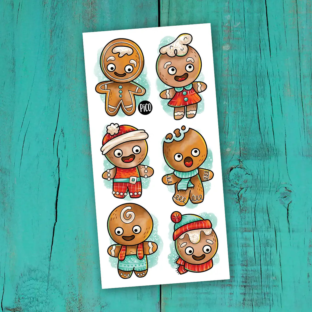 Tatouages temporaires biscuits en pain d'épice, motifs festifs colorés pour enfants.
Gingerbread cookie temporary tattoos, colorful festive designs for kids.